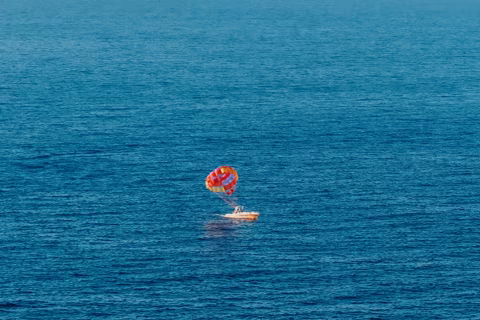 A colorful parasail above the deep blue Pacific Ocean